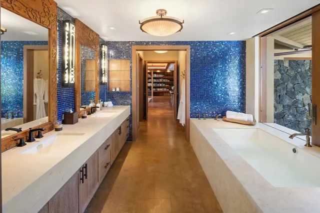 a spacious bathroom with a double vanity sink and a bathtub