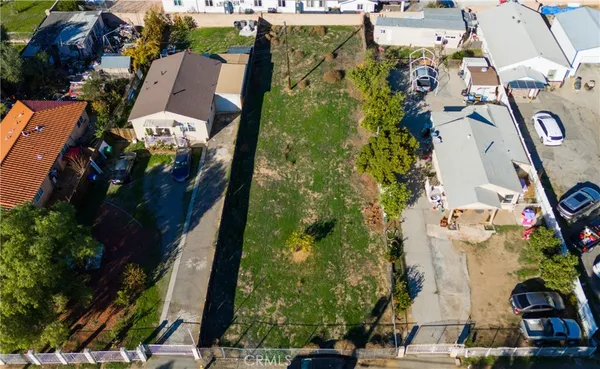 an aerial view of a house with a yard and fountain