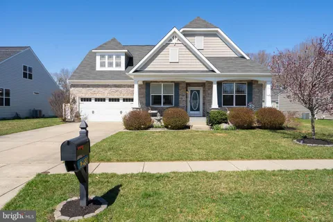 a view of a dining room with furniture wooden floor and chandelier