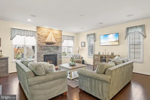 a living room with furniture kitchen view and a potted plant