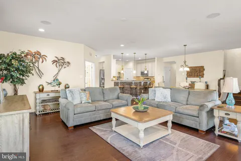 a living room with furniture a fireplace and a chandelier
