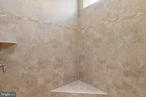 a bathroom with a sink toilet vanity and shower