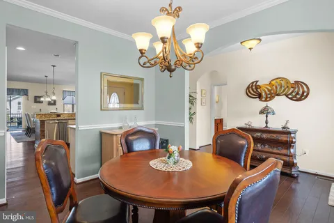 a view of a dining room with furniture wooden floor and a chandelier