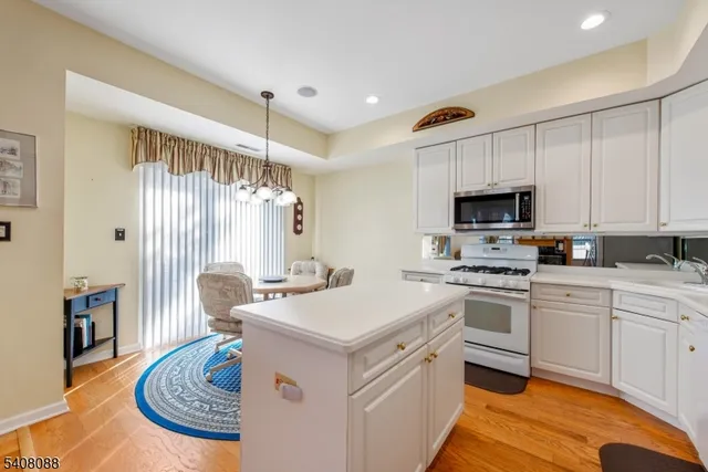 a kitchen that has a stove a sink and a refrigerator