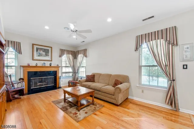 a living room with furniture a fireplace and a large window