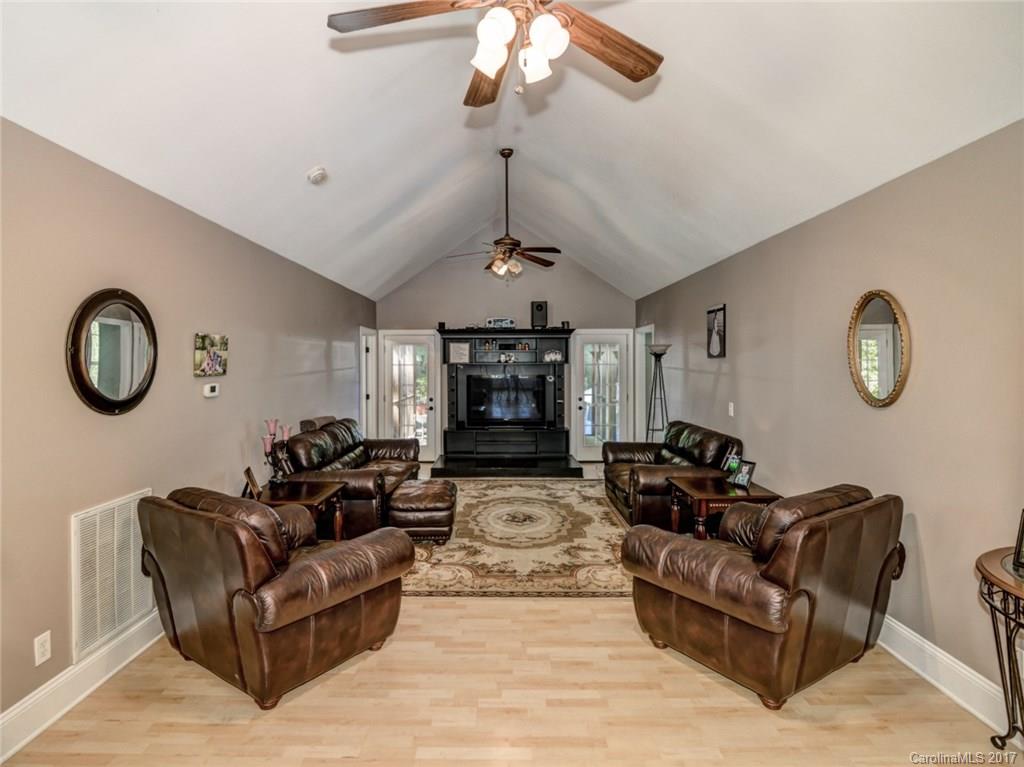 2789 Bush Road Clover, SC 29710 - Photo 12 of 24 a living room with couches a fireplace and a chandelier