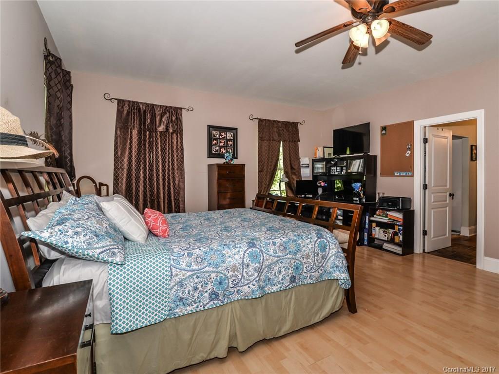 2789 Bush Road Clover, SC 29710 - Photo 14 of 24 a bedroom with a bed and dresser with wooden floor