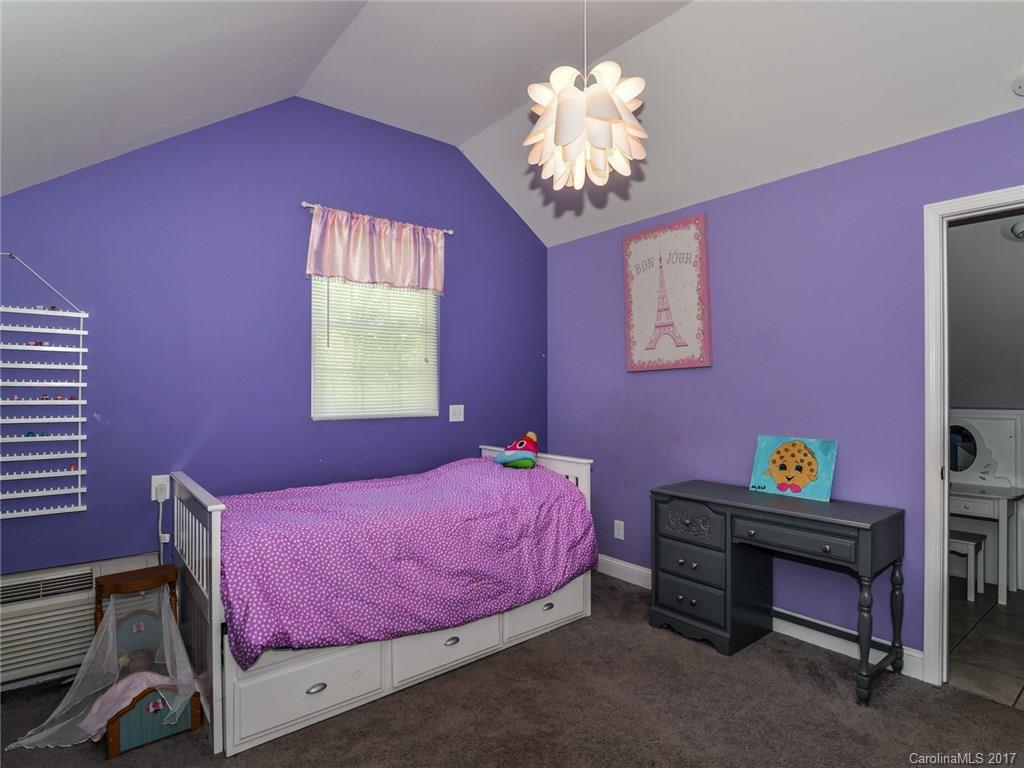 2789 Bush Road Clover, SC 29710 - Photo 20 of 24 a bedroom with a bed and a chandelier