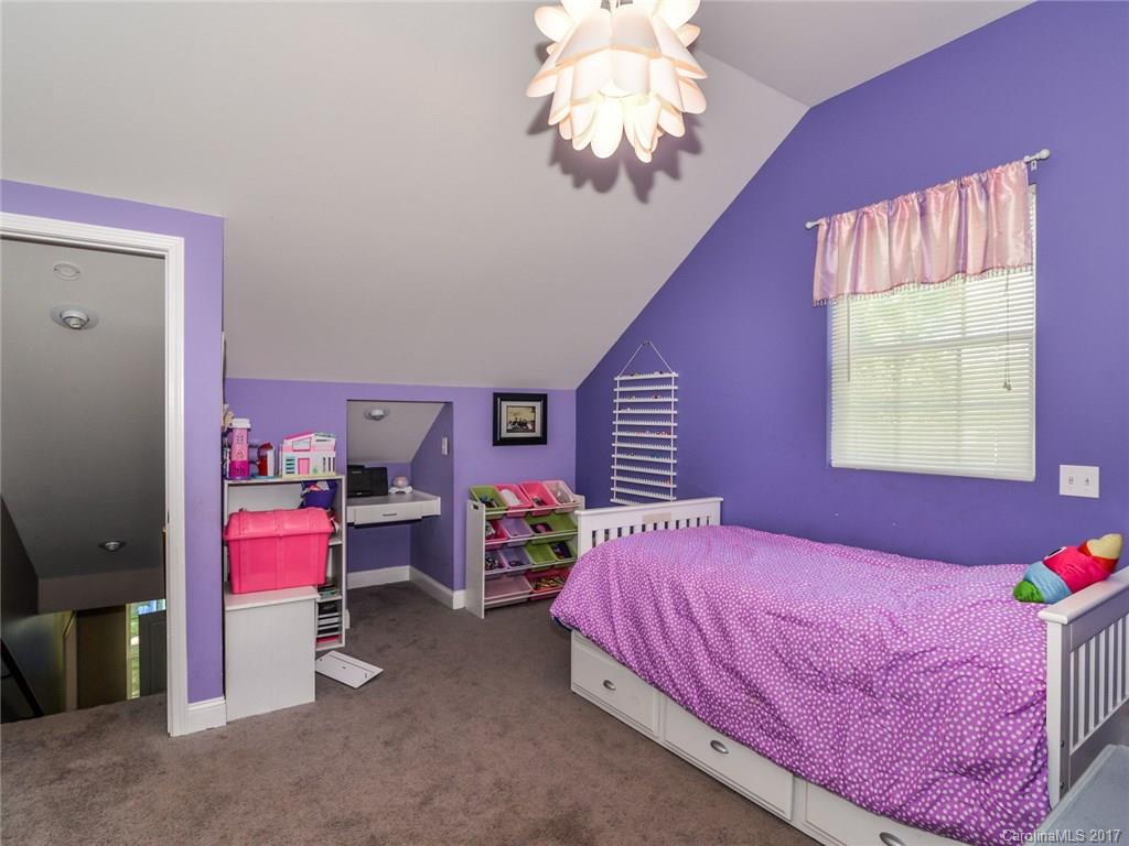 2789 Bush Road Clover, SC 29710 - Photo 21 of 24 a bedroom with a bed and a chandelier