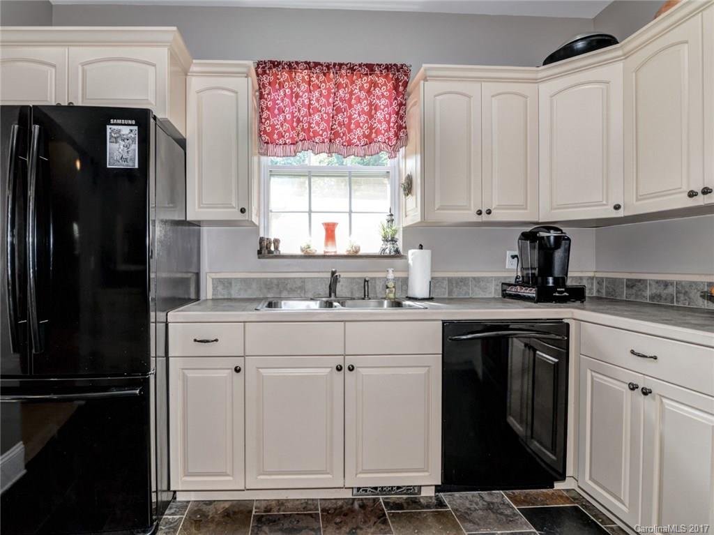 2789 Bush Road Clover, SC 29710 - Photo 8 of 24 a kitchen with white cabinets and a refrigerator