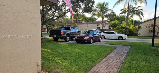 a group of cars parked in front of a house