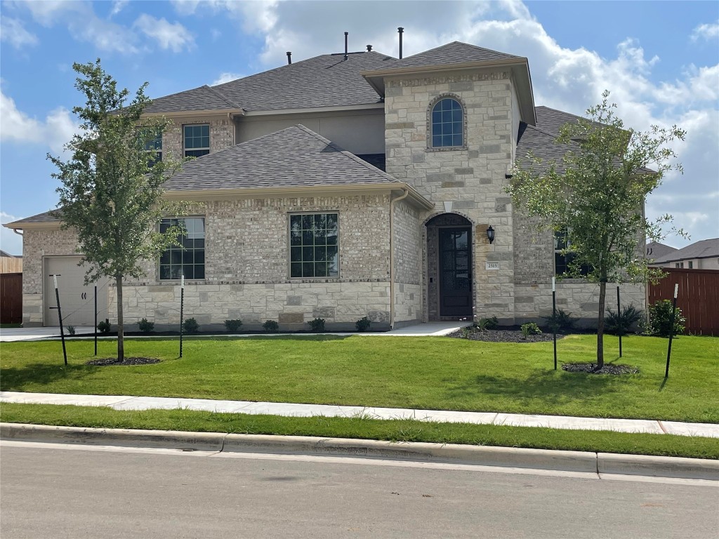a front view of a house with a garden
