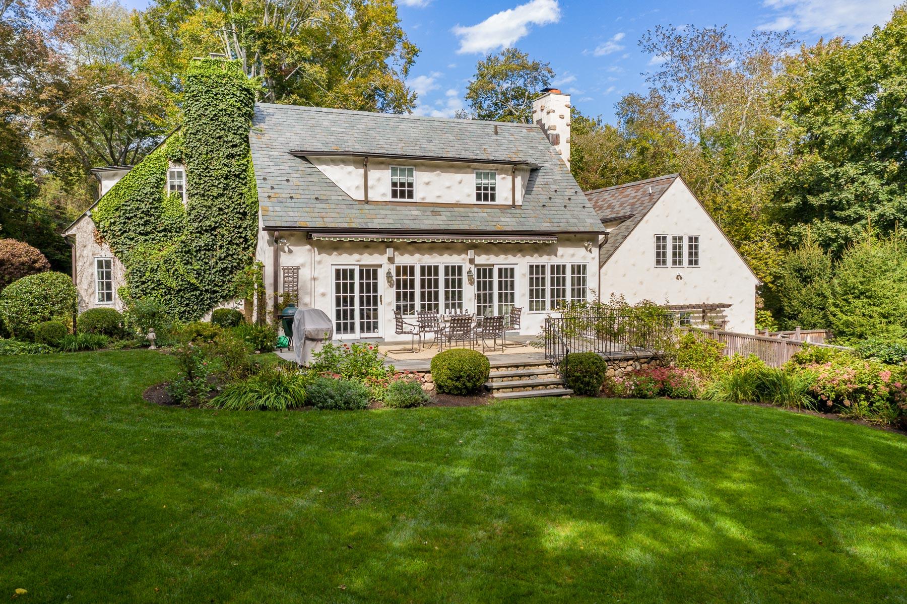 10 Meadowbrook Road Darien, CT 06820 - Photo 2 of 42 a front view of a house with a yard and garage