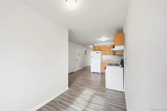 a view of a kitchen with wooden floor