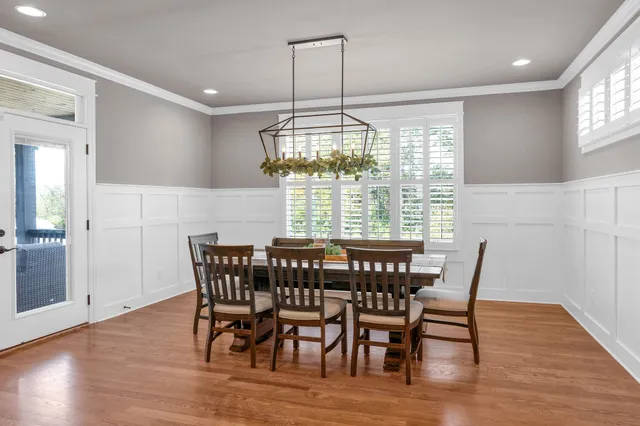 a view of a dining room with furniture wooden floor and chandelier