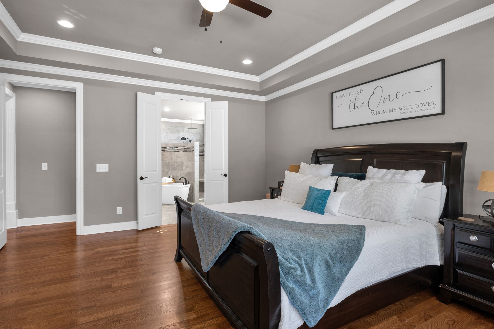 1032 Abbey Rd Way Spring Hill, TN 37174 - Photo 23 of 51 a bedroom with a large bed and a chandelier
