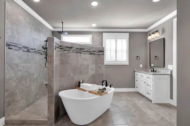 a bathroom with a sink mirror and a bathtub