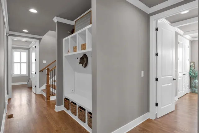 a view of entryway with wooden floor and stairs