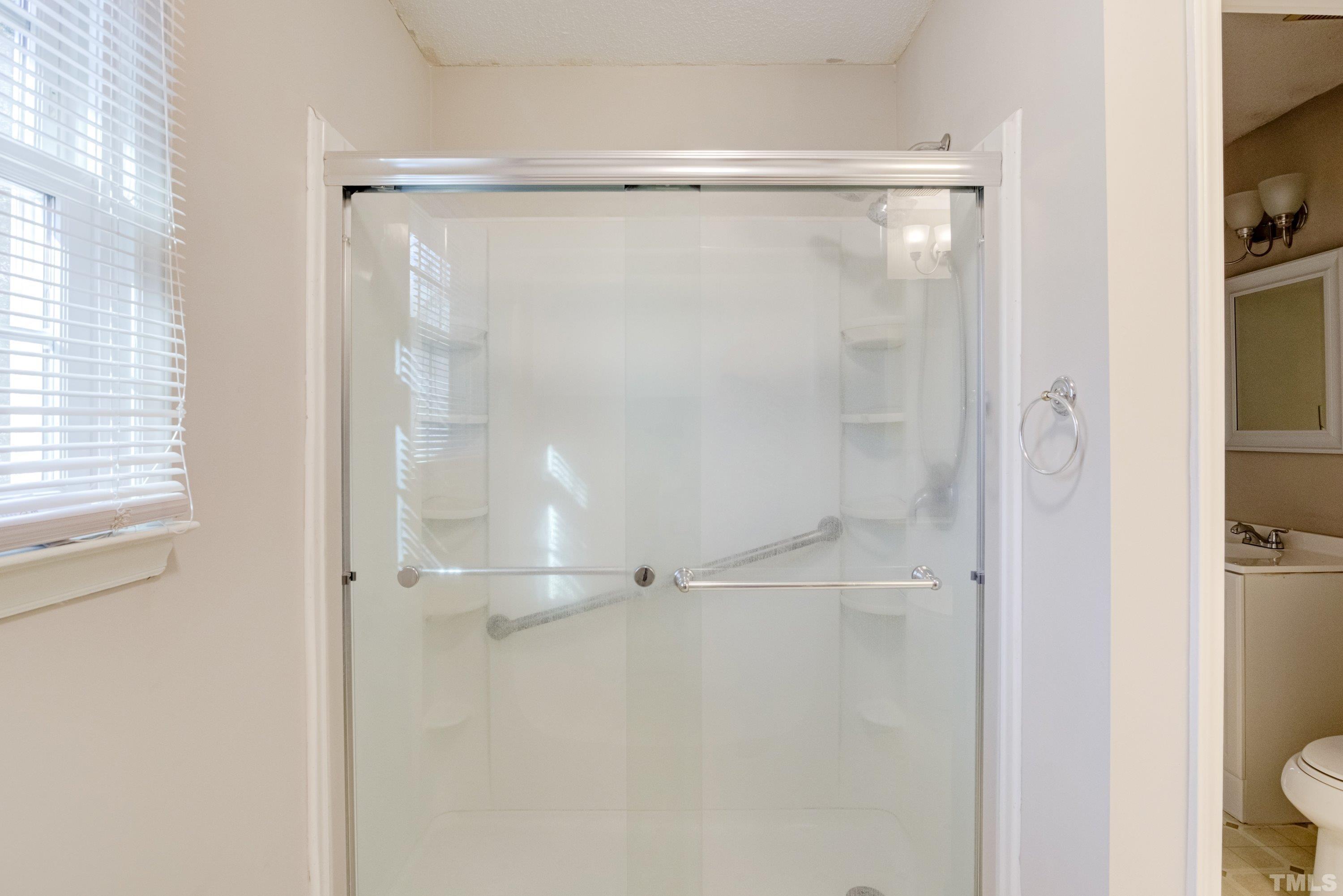 5149 Shield Circle Raleigh, NC 27603 - Photo 23 of 41 a bathroom with a glass shower door