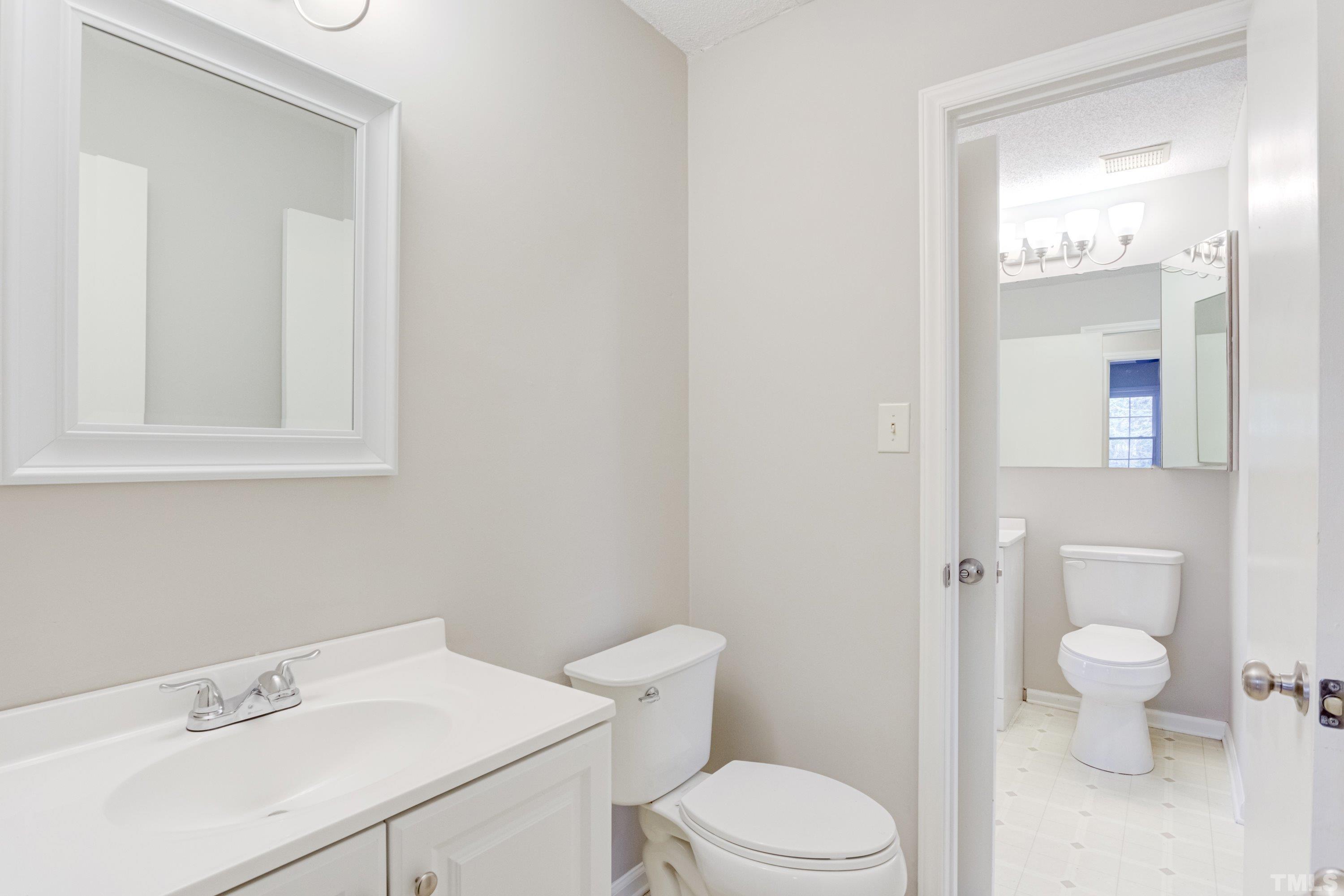 5149 Shield Circle Raleigh, NC 27603 - Photo 24 of 41 a white toilet sitting next to a bathroom sink