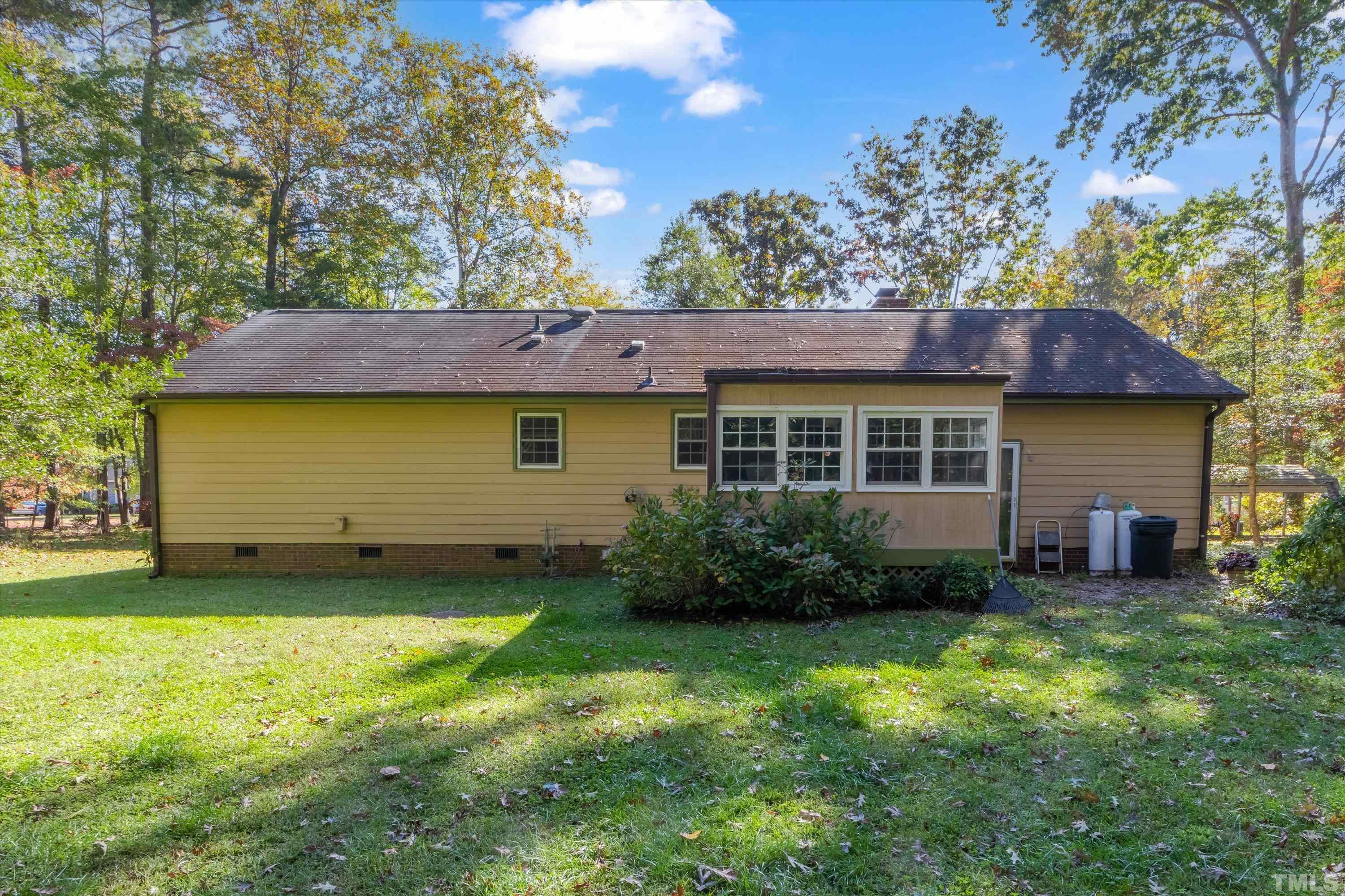 5149 Shield Circle Raleigh, NC 27603 - Photo 34 of 41 a view of a backyard with plants and large tree