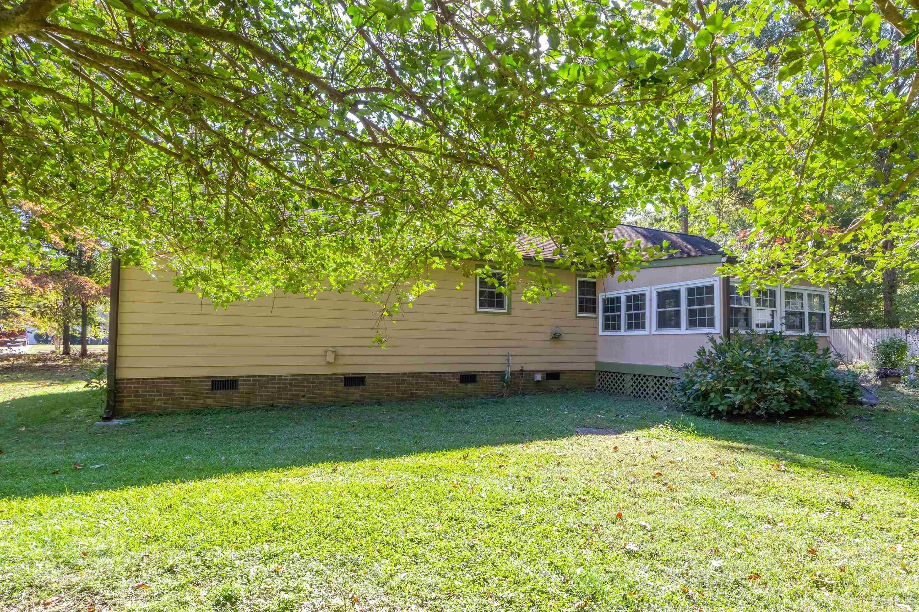 5149 Shield Circle Raleigh, NC 27603 - Photo 35 of 41 a view of a backyard with plants and large trees