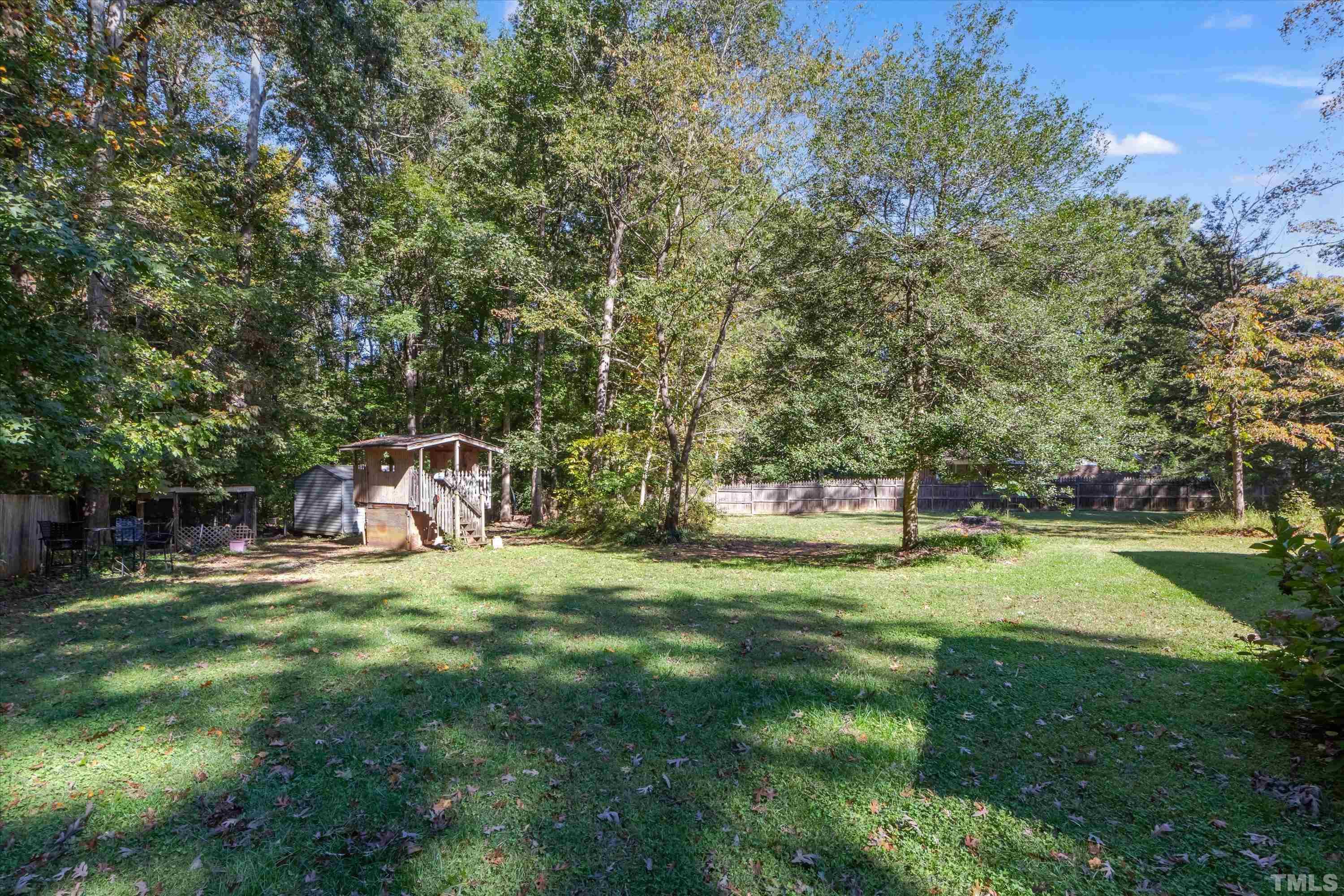 5149 Shield Circle Raleigh, NC 27603 - Photo 39 of 41 a backyard of a house with table and chairs
