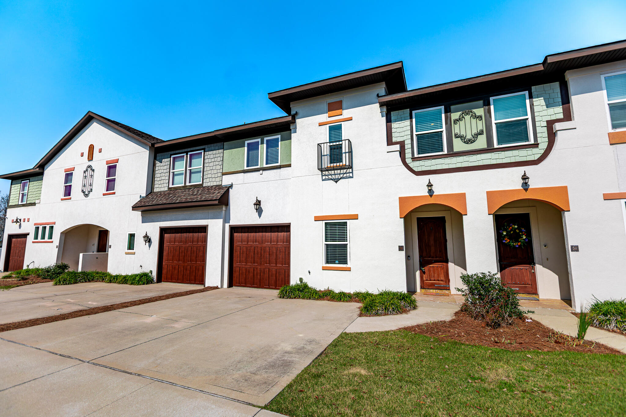 995 Airport Road, Unit 54 Destin, FL 32541 - Photo 1 of 31 a front view of a house with a yard and garage