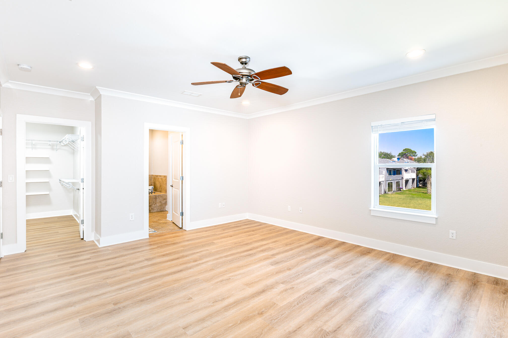 995 Airport Road, Unit 54 Destin, FL 32541 - Photo 16 of 31 wooden floor in an empty room with a window