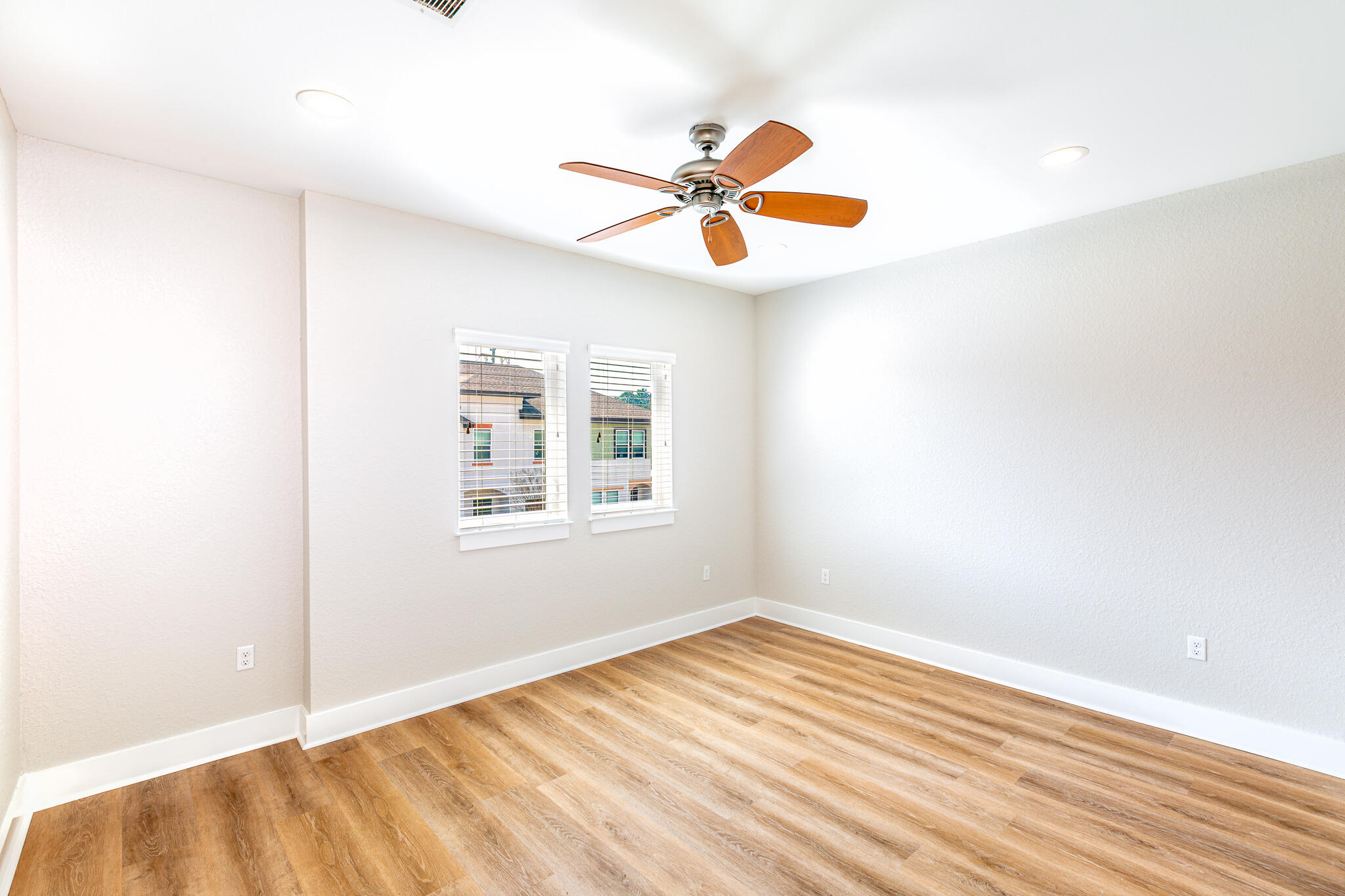 995 Airport Road, Unit 54 Destin, FL 32541 - Photo 21 of 31 a view of an empty room with wooden floor and a window