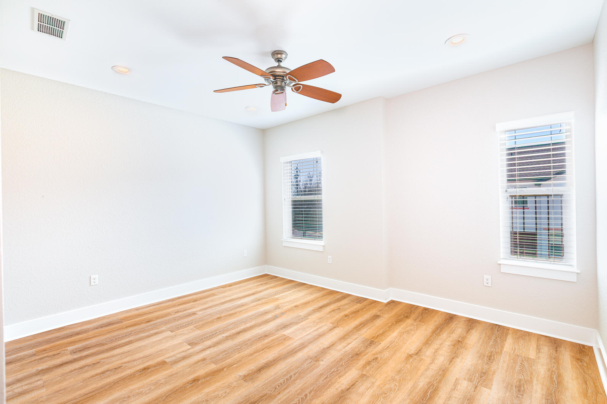 995 Airport Road, Unit 54 Destin, FL 32541 - Photo 24 of 31 a view of an empty room with wooden floor and a window