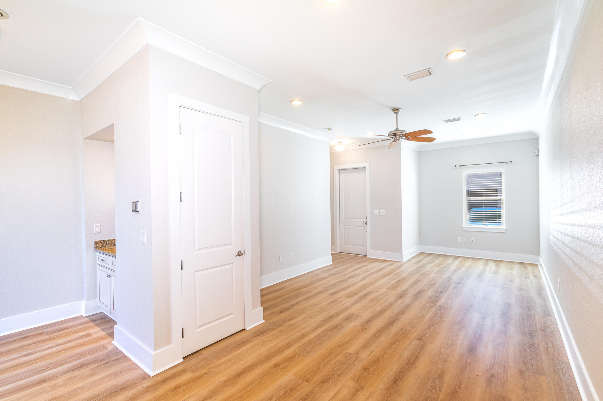 995 Airport Road, Unit 54 Destin, FL 32541 - Photo 9 of 31 an empty room with wooden floor and windows