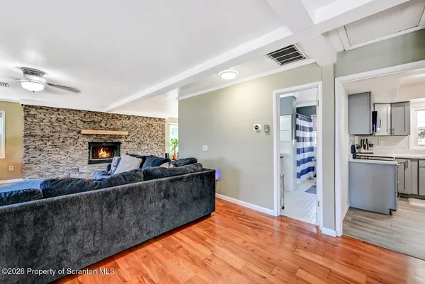 a living room with furniture and wooden floor