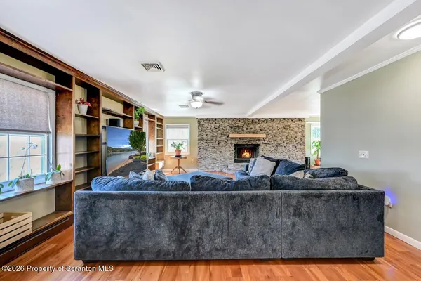 a living room with furniture and a fireplace