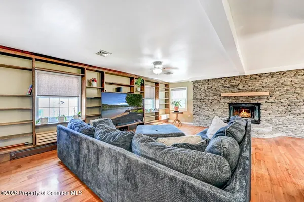 a living room with furniture and a wooden floor