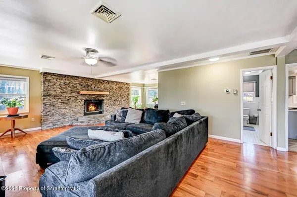 a living room with furniture and a fireplace