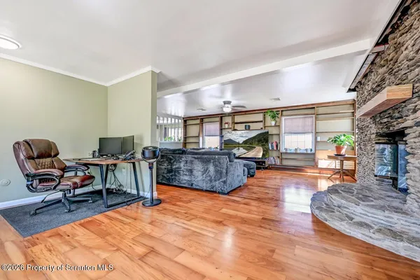 a living room with furniture flat screen tv and a large window