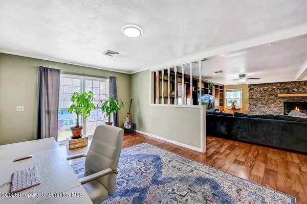a living room with stainless steel appliances kitchen island granite countertop a couch and a fireplace