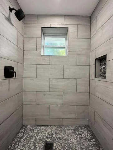 a bathroom with a shower and a window