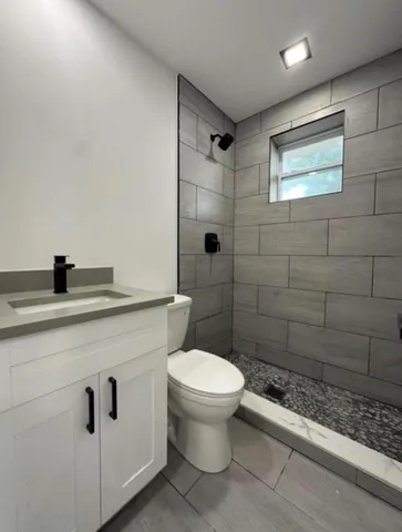 a bathroom with a toilet sink and shower