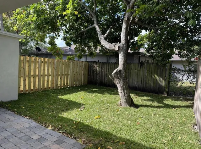 a garden with wooden fence
