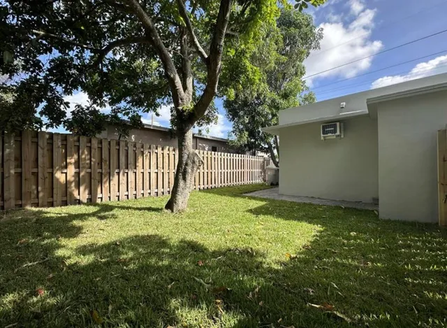 a view of a backyard with a small cabin and a chair