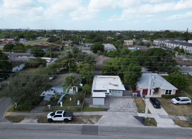 an aerial view of residential houses and car parked