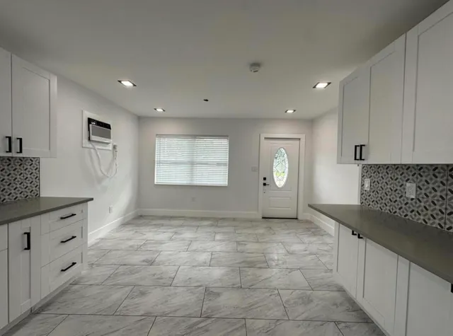 a view of a kitchen with a sink cabinets and window