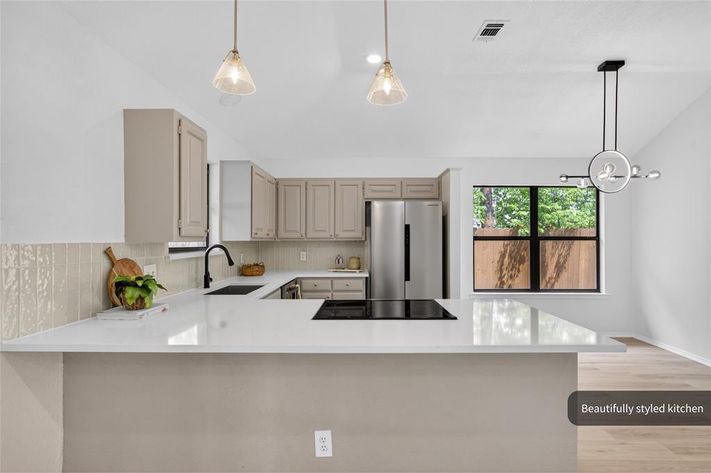 509 Brookside Court Burleson, TX 76028 - Photo 5 of 18 a kitchen with a sink a window and cabinets