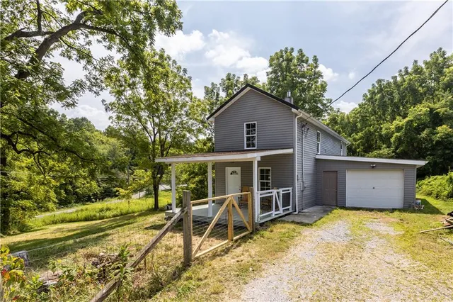 a view of a house with a yard and sitting area