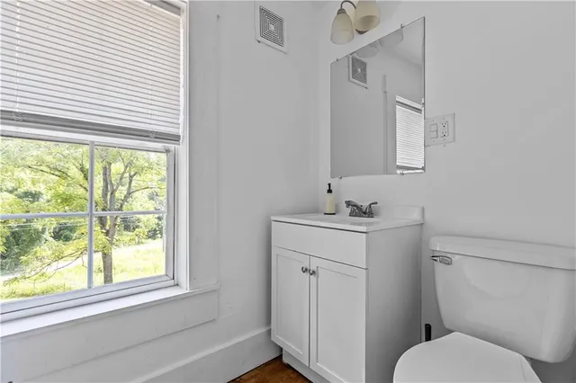 a bathroom with a toilet sink and mirror