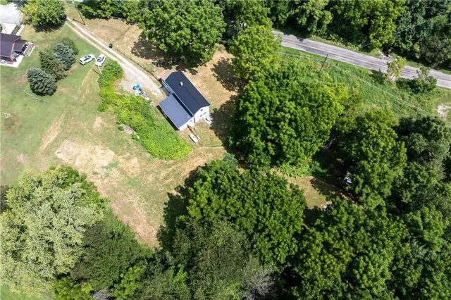 an aerial view of a house with a yard