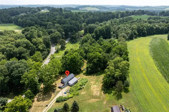 a aerial view of a house with a yard