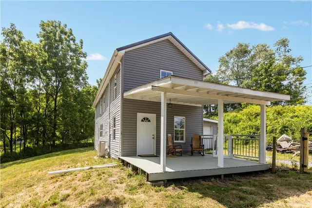 a view of a house with backyard and balcony